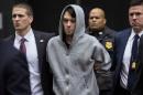 FILE - In this Thursday, Dec. 17, 2015, file photo, Martin Shkreli, center, the former hedge fund manager under fire for buying a pharmaceutical company and ratcheting up the price of a life-saving drug, is escorted by law enforcement agents in New York after being taken into custody following a securities probe. U.S. Rep. Elijah Cummings, D-Maryland, said a lawyer for Shkreli indicated he has not sought permission from a New York judge to appear at a congressional hearing Tuesday, Jan. 26, 2016, on drug prices, despite receiving a subpoena. (AP Photo/Craig Ruttle, File)