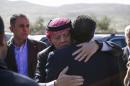 Jordan's King Abdullah embraces Fahed al-Kasaesbeh, the uncle of Jordanian pilot Muath al-Kasaesbeh, as he arrives to offer his condolences at the headquarters of the family's clan in the city of Karak