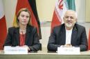 European Union High Representative Federica Mogherini and Iranian Foreign Minister Javad Zarif wait for a meeting with officials from P5+1, the European Union and Iran at the Beau Rivage Palace Hotel in Lausanne