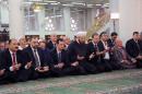 In this photo released by the Syrian official news agency SANA, Syrian President Bashar Assad, third left, prays on the first day of Eid al-Adha at the Sayeda Hassiba mosque, in Damascus, Syria, Tuesday, Oct. 15, 2013. (AP Photo/SANA)