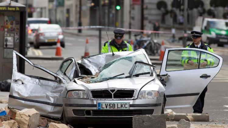 Police officers work at the site where masonry from a building collapsed on a in high winds in central London, on February 15, 2014