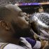 Baltimore Ravens defensive end Arthur Jones (97) kisses the Vince Lombardi Trophy after defeating the San Francisco 49ers 34-31 in the NFL Super Bowl XLVII football game, Sunday, Feb. 3, 2013, in New Orleans. (AP Photo/Dave Martin)