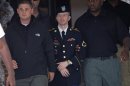U.S. Army Pfc. Bradley Manning is escorted out of a courthouse , during his court martial at Fort Meade in Maryland