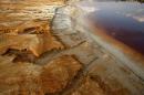 FILE PHOTO - Polluted water emanating from mining operations fills a dam near Johannesburg