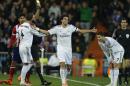 Real's Pepe, center, and Cristiano Ronaldo, right, laugh as Pepe gets a yellow card during the semifinal, 1st leg, Copa del Rey soccer derby match between Real Madrid and Atletico Madrid at the Santiago Bernabeu Stadium in Madrid, Wednesday Feb. 5, 2014. (AP Photo/Paul White)