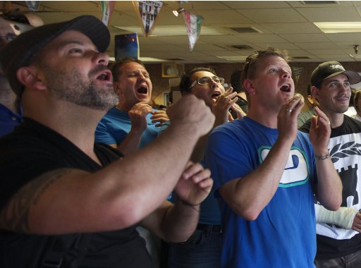 Soccer fans react while watching the Euro 2012 semi-final between Italy and Germany in Vancouver