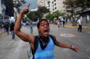 A demonstrator shouts slogans against Bolivarian National Guards during clashes in Caracas, Venezuela, Sunday, March 2, 2014. Since mid-February, anti-government activists have been protesting high inflation, shortages of food stuffs and medicine, and violent crime in a nation with the world's largest proven oil reserves. (AP Photo/Rodrigo Abd)