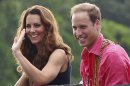 Britain's Prince William and his wife Kate, the Duke and Duchess of Cambridge, smile as they watch a shark ceremony as they arrive at Marapa Island, Solomon Islands, Monday, Sept. 17, 2012. (AP Photo/Rick Rycroft, Pool)