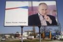 A billboard with a portrait of Russian President Vladimir Putin is displayed on a street in Kerch, Crimea