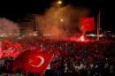 Supporters of Turkish President Tayyip Erdogan wave Turkish national flags during a pro-government demonstration on Taksim square in Istanbul