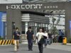 Workers walk out of the entrance to a Foxconn factory in Chengdu