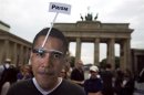 Man wears a mask of U.S. President Obama during a protest in support of former U.S. spy agency contractor Snowden in Berlin