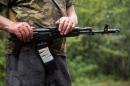A Ukrainian serviceman holds his rifle as he combs the area with comrades after being shot at by pro-Russian militants at their check-point near the small city of Dzerzhynsk, in the Donetsk region, on August 28, 2014