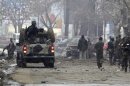 Afghan security forces investigate at the site of car bomb attack in Kabul