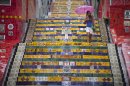 A woman descends a stairway that was decorated by Chilean artist Jorge Selaron, which he titled the "Selaron Stairway" in Rio de Janeiro, Brazil, Thursday, Jan. 10, 2013. Selaron, an eccentric Chilean artist and longtime Rio resident who created a massive, colorful tile stairway in the bohemian Lapa district that's popular with tourists, was found dead on the stairway on Thursday. He was 54. Authorities are investigating the cause of death. (AP Photo/Felipe Dana)