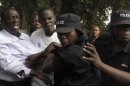 Ugandan policemen arrest opposition leader Besigye ahead of a rally to demonstrate against corruption and economic hardships in Uganda's capital Kampala