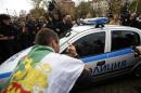 Protesters try to block a police vehicle during a demonstration near the parliament in central Sofia