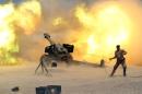 A member of the Iraqi security forces fires artillery during clashes with Islamic State militants near Falluja