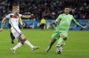 Germany's Andre Schuerrle, left, takes a shot past Germany's Benedikt Hoewedes during the World Cup round of 16 soccer match between Germany and Algeria at the Estadio Beira-Rio in Porto Alegre, Brazil, Monday, June 30, 2014. (AP Photo/Kirsty Wigglesworth)