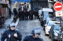 French police are seen near the Rue de la Goutte d'Or in the north of Paris on January 7, 2016, after police shot a man dead as he was trying to enter a police station