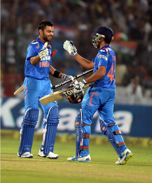 Indian players Rohit Sharma and Virat Kohli celebrates win during the 2nd ODI match between India and Australia being played at Sawai Mansingh Stadium, Jaipur on Oct. 16, 2013. (Photo: IANS)