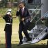 U.S. President Obama salutes as he steps off Marine One at the White House in Washington