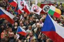 Several hundred people hold banners and Czech national flags during an anti-immigrants rally on October 28, 2015 in Prague