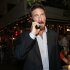 Anti-virus software founder John McAfee talks on his mobile phone as he walks on Ocean Drive in the South Beach area of Miami Beach, Fla., on his way to dinner Wednesday, Dec 12, 2012. McAfee arrived in the U.S. on Wednesday night after being deported from Guatemala, where he had sought refuge to evade police questioning in the killing of a man in neighboring Belize. (AP Photo/Alan Diaz)