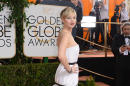 Jennifer Lawrence arrives at the 71st annual Golden Globe Awards at the Beverly Hilton Hotel on Sunday, Jan. 12, 2014, in Beverly Hills, Calif. (Photo by Jordan Strauss/Invision/AP)