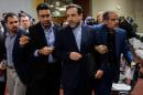 Iran's Deputy Foreign Minister Abbas Araqchi (C) is surrounded by journalists following a press conference closing the third day of talks on Iran's nuclear programme, on November 10, 2013 in Geneva