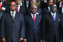 In this handout photo supplied by the South African Government Communications and Information Services, (GCIS) presidents Jacob Zuma, of South Africa, left, Armando Guebuza, center, of Mozambique and Robert Mugabe of Zimbabwe, right, at a special summit on Zimbabwe in Mozambique Saturday, June 15, 2013. Regional presidents opened the special summit after President Robert Mugabe set crucial elections for the end of July, despite opposition from the country's prime minister. (AP Photo/Kopano Tlape - GCIS)