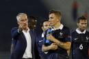 Head coach of the French national soccer team Didier Deschamps, left, speaks with players after his international friendly soccer match against Serbia, in Belgrade, Serbia, Sunday, Sept. 7, 2014. (AP Photo/Darko Vojinovic)