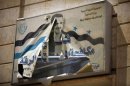 A torn picture of Syria's President Bashar al-Assad is seen on a government building in Raqqa province