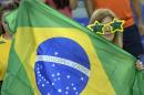A Brazil fan holds a flag during FIFA Women's World Cup soccer action against Spain in Montreal on Saturday, June 13, 2015. (Paul Chiasson/The Canadian Press via AP) MANDATORY CREDIT