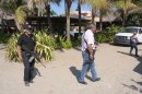 Police patrol on the beach outside a home after masked armed men broke into the home in Acapulco, Mexico, Tuesday Feb. 5, 2013. According to the mayor of Acapulco, five masked men burst into the house that Spanish tourists had rented on the outskirts of Acapulco, in a low-key area near the beach, and held a group of six Spanish men and one Mexican woman at gunpoint, while they raped the six Spanish women before dawn on Monday. (AP Photo/Bernandino Hernandez)