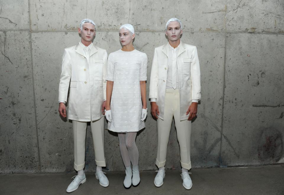 Models pose for photographs before the Thom Browne Fall 2015 collection is shown during New York Fashion Week, Monday, Feb. 16, 2015. (AP Photo/Diane...