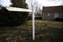 An empty post where a "for sale" sign used to hang is seen outside a home in Brentwood,