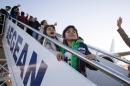 Iraqi refugees board a plane at Athens airport on November 4, 2015, bound for Luxembourg
