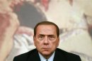 Italy's Prime Minister Berlusconi looks on during a news conference at Chigi Palace in Rome