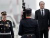 French President Francois Hollande, right, stands next to the honor guard as he listens to the French national anthem during a ceremony at the Eleftherios Venizelos airport, Athens, Tuesday, Feb. 19, 2013. Hollande is in Greece on a one day official visit. (AP Photo/Petros Giannakouris)