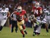 San Francisco 49ers' Gore runs for a 20-yard gain against Seattle Seahawks' Branch and Hill during their NFL football game in San Francisco