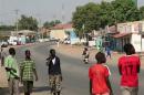 South Sudanese people walk along a street in capital Juba