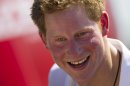 FILE - This is a Saturday March 10, 2012 file photo of Britain's Prince Harry, smiles after playing rugby at Flamengo's beach in Rio de Janeiro, Brazil. Photographs of a naked Prince Harry in a Las Vegas hotel room have popped up online. A celebrity gossip site published two pictures of the 27-year-old royal cavorting with what they called a mystery woman in a VIP suite. Prince Harry's office confirmed Wednesday Aug. 22. 2012 that the photos were of the prince but declined to make any further comment. (AP Photo/Felipe Dana, File)