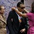 Retired boxing champion Muhammad Ali, center, receives the Liberty Medal from his daughter Laila Ali with his wife Lonnie Ali at his left during a ceremony at the National Constitution Center, Thursday, Sept. 13, 2012, in Philadelphia. The honor is given annually to an individual who displays courage and conviction while striving to secure liberty for people worldwide. (AP Photo/Matt Rourke)
