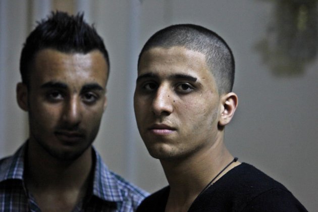 Ayman al-Sayed, 19, right, with his hair cut, and his friend Mohammed Hanouna, 18, left, pose for photo during an interview in Gaza City, Sunday, April 7, 2013. Al-Sayed used to have shoulder-length hair but says he was grabbed by Hamas police in a sweep along with other young men with long or gel-styled spiky hair last week, and that police shaved everyone's head. Hanouna still wears the hair-style that can now get young men in trouble in Gaza, during the Islamic militants latest attempt to impose their hardline version of Islam on Gaza. (AP Photo/Adel Hana)