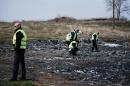 Dutch investigators work at the crash site of the Malaysia Airlines Flight MH17 near the village of Grabove in eastern Ukraine on March 24, 2015