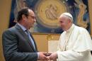 Pope Francis and French President Francois Hollande, left, exchange gifts on the occasion of their private audience at the Vatican, Wednesday, Aug. 17, 2016. Hollande is visiting Pope Francis for a special audience after a spate of Islamic extremist attacks over recent months left more than 200 dead, including an elderly French priest. (L'Osservatore Romano/Pool Photo via AP)