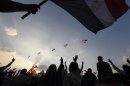 Military helicopters fly above Tahrir Square while protesters opposing Egyptian President Mohamed Mursi shout slogans against him and Brotherhood members during a protest in Cairo