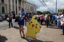 Cosplayer dressed as a character of the augmented reality mobile game "Pokemon Go" by Nintendo participate in a "poketour" organized by the municipality in San Salvador
