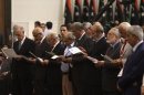 Members of the national congress take an oath during handover ceremony of power the National Transitional Council in Tripoli